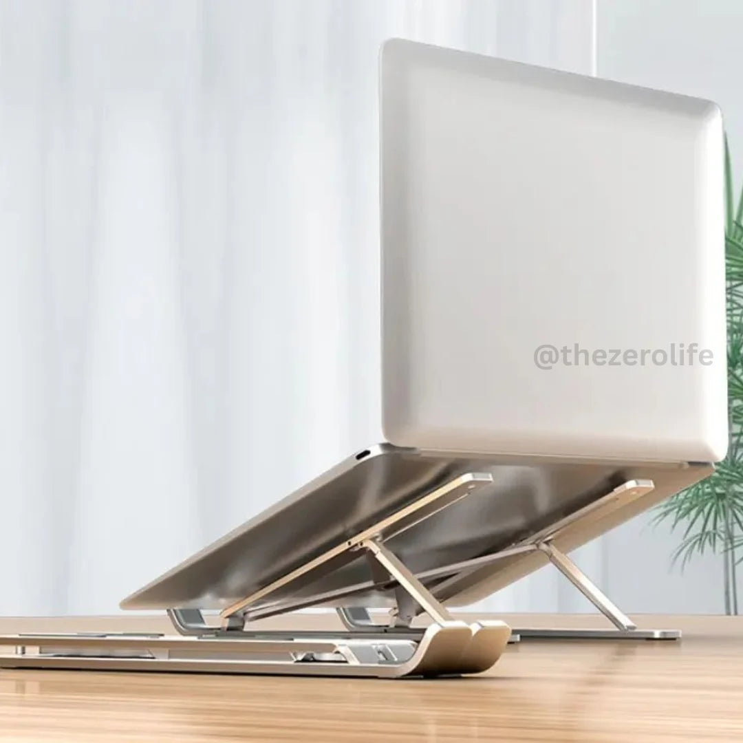 Laptop on a stand with a white screen on a wooden surface