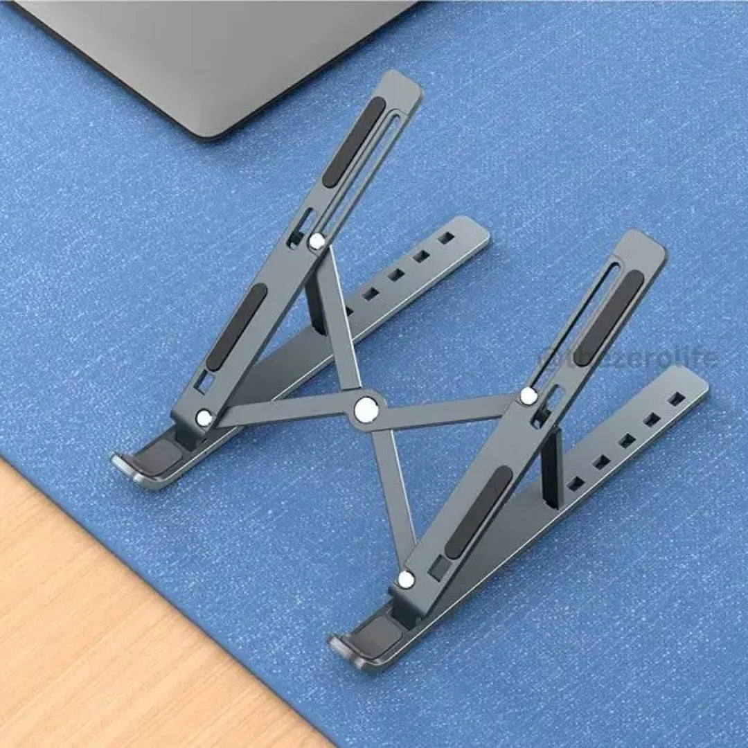 Foldable laptop stand on a blue surface with a laptop partially visible.