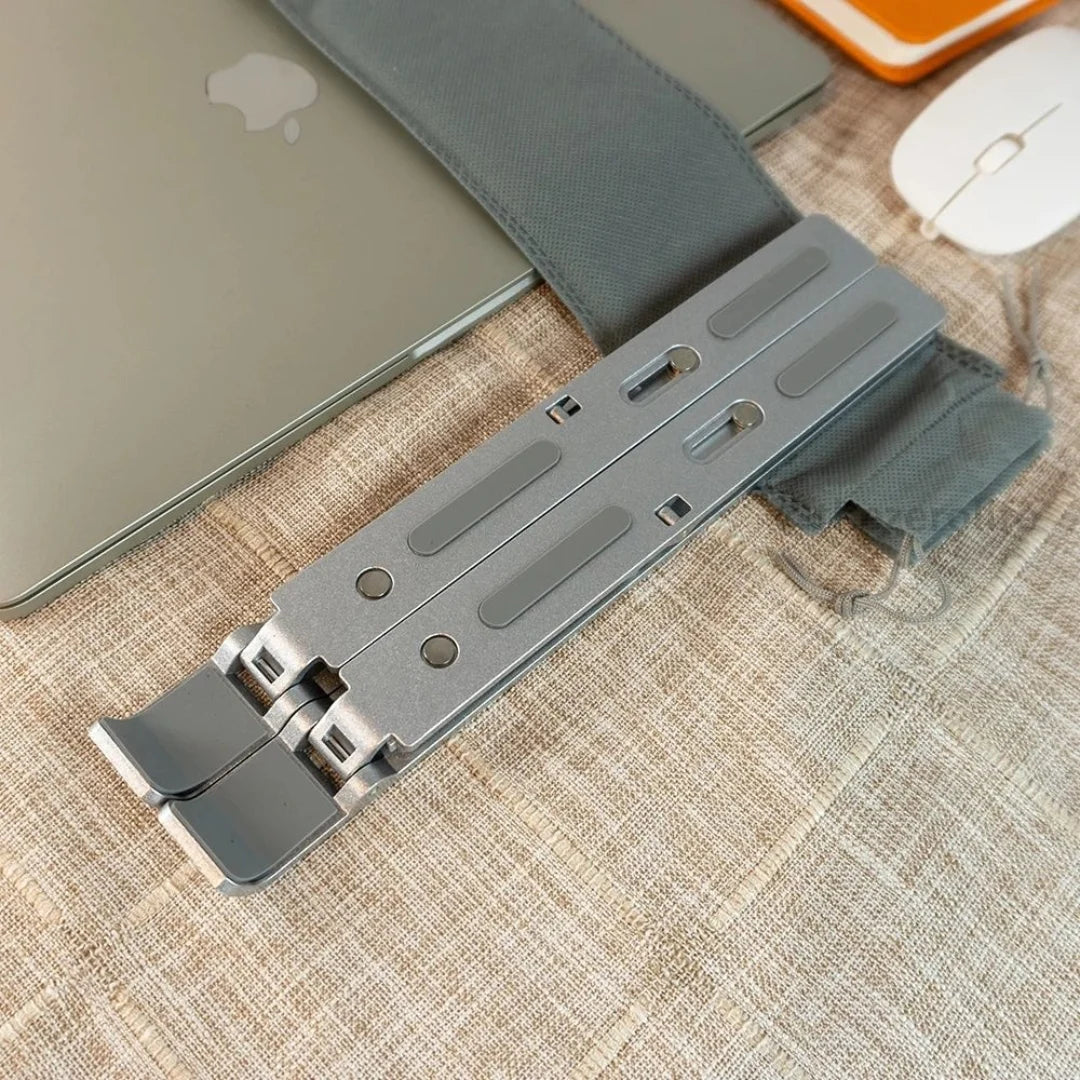 Laptop stand on a textured surface with a laptop and mouse in the background