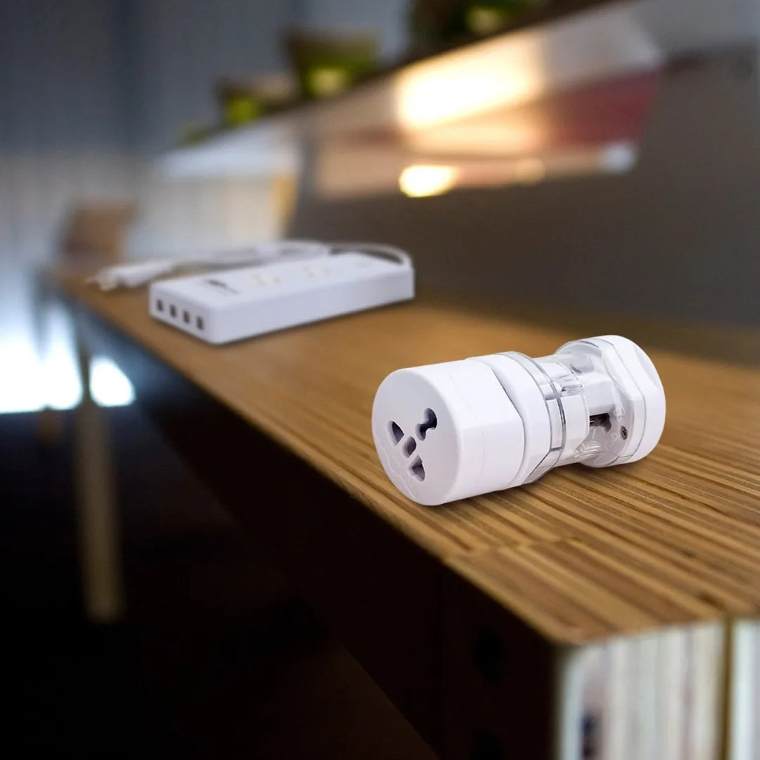 White electronic device on a wooden surface with a blurred background