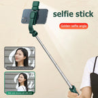 Green selfie stick with smartphone holder on a beige background