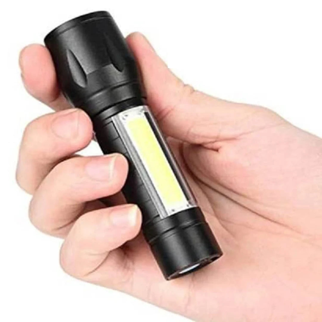 Hand holding a black flashlight with a clear COB light module on a white background