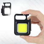 Hand holding a small black light with yellow center, inset with a similar product on a white background.