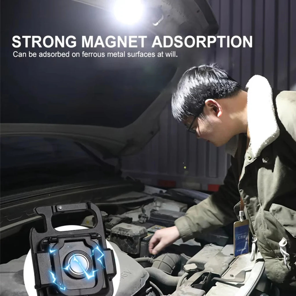 Person working on a car with a strong magnet device in the foreground.
