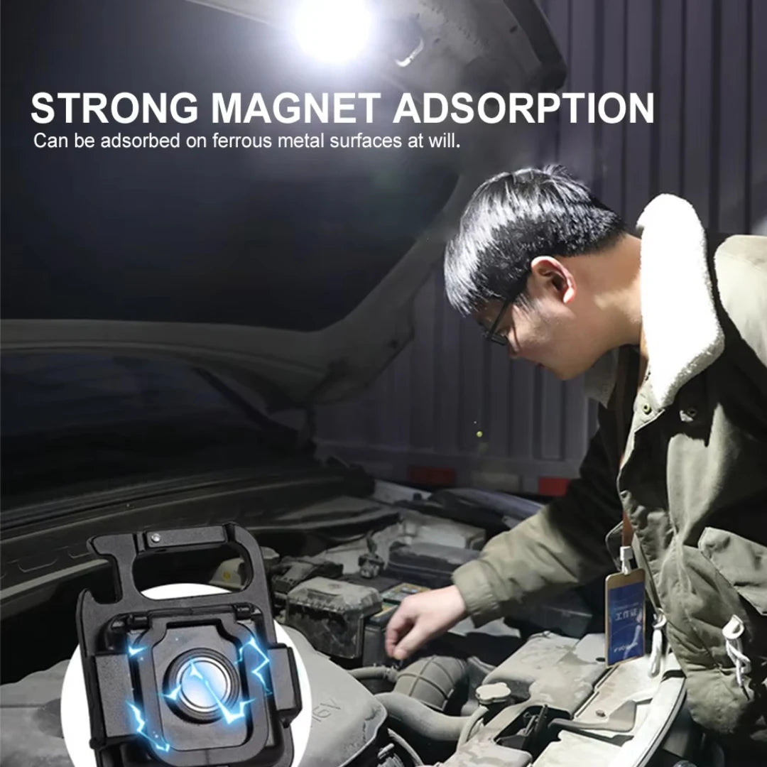 Person working on a car with a strong magnet device in the foreground.