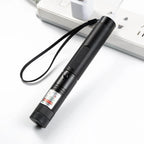 Black laser pointer on a white surface with a blurred background