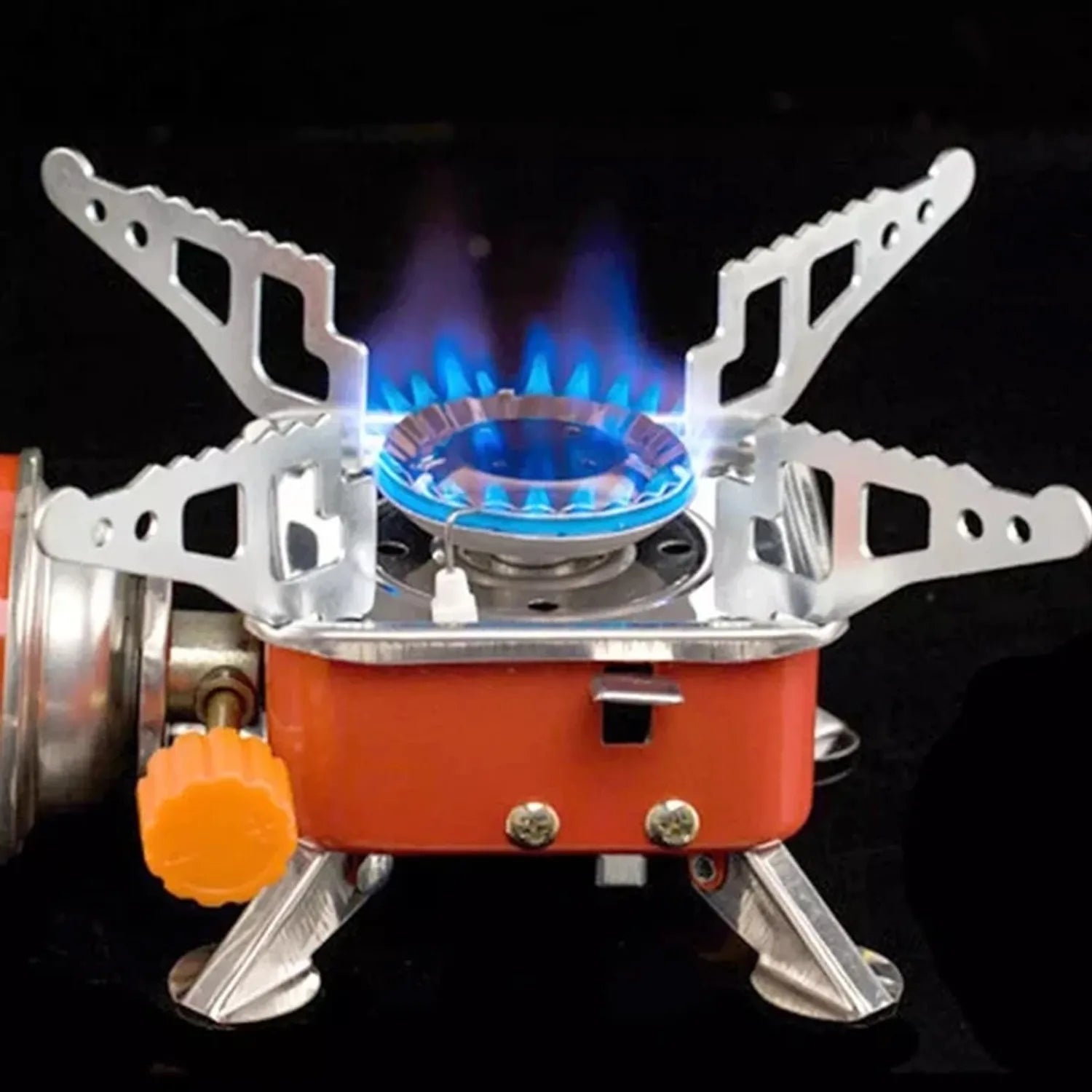 Portable gas stove with blue flame on a black background