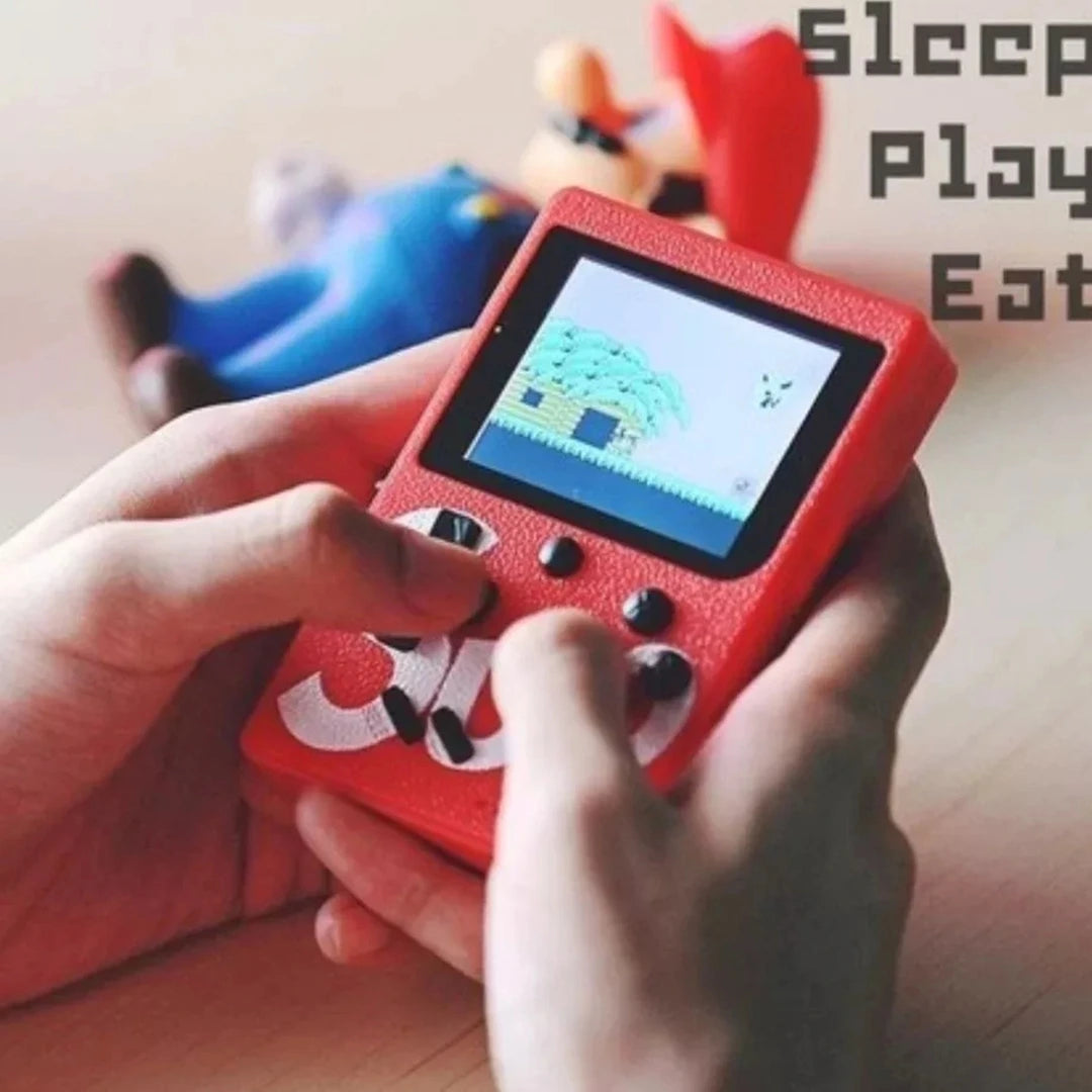 Red handheld gaming console with a game displayed, held by hands on a wooden surface.